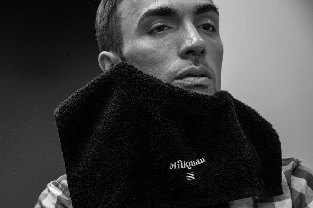 man wiping face with milkman bamboo face towel