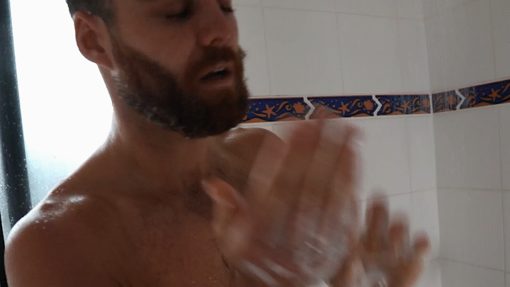 man washing his beard with shampoo and conditioner 