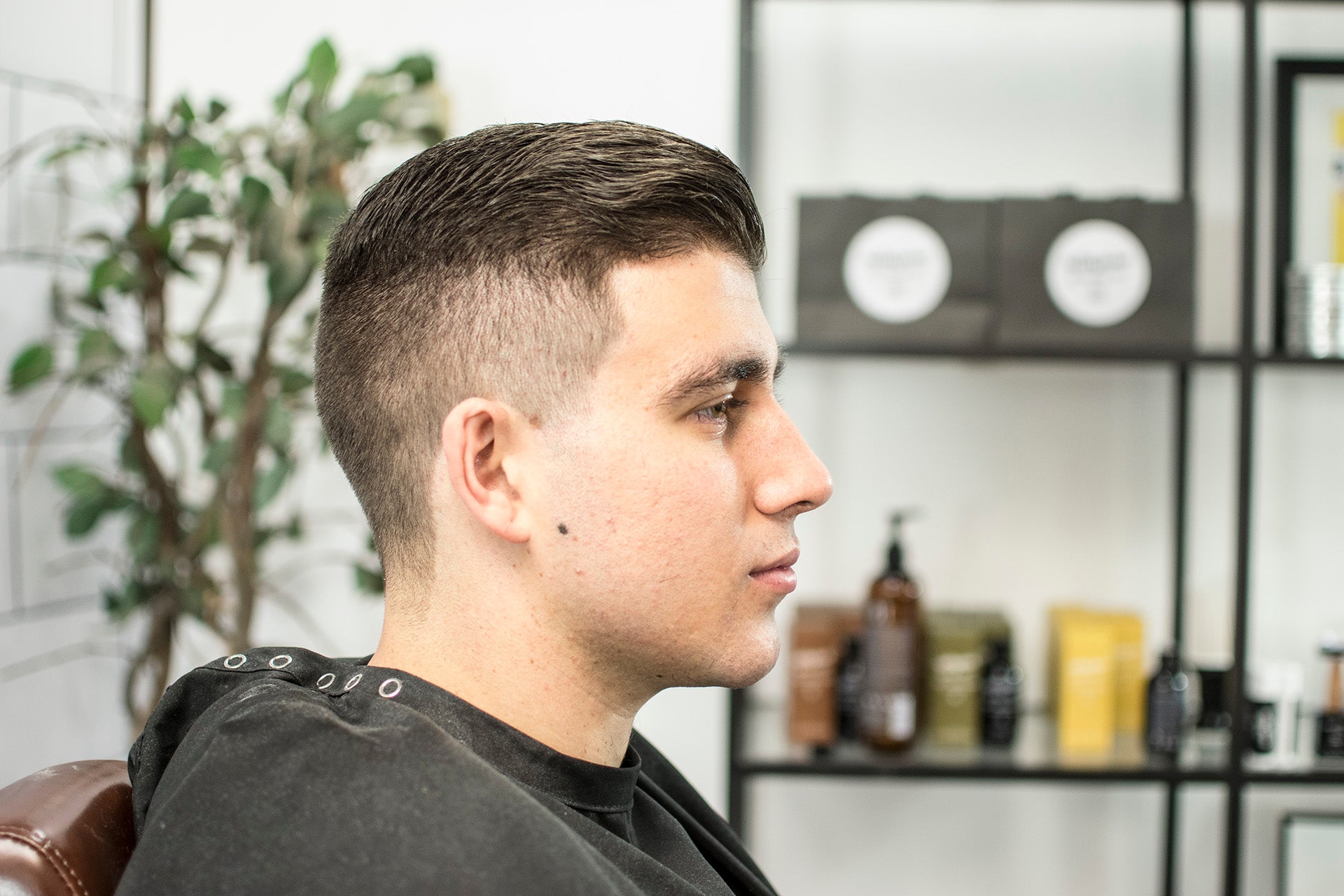 profile of man using matte clay pomade