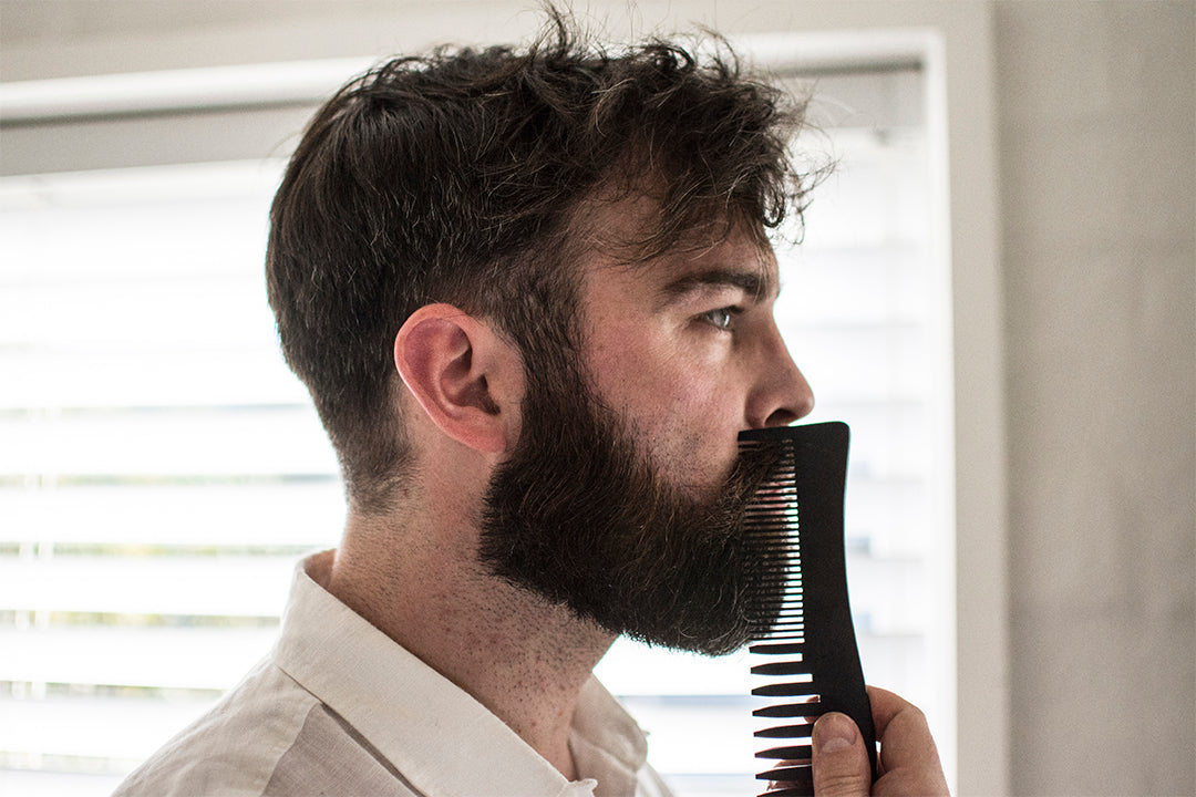 man combing beard