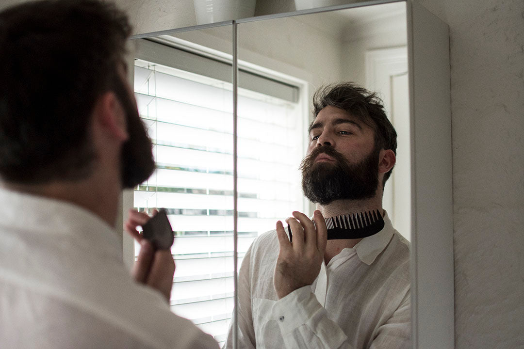 bearded man sculpting beard with travel size products