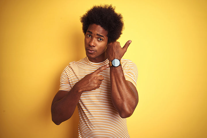 man pointing to watch letting you know you need to save time in the morning