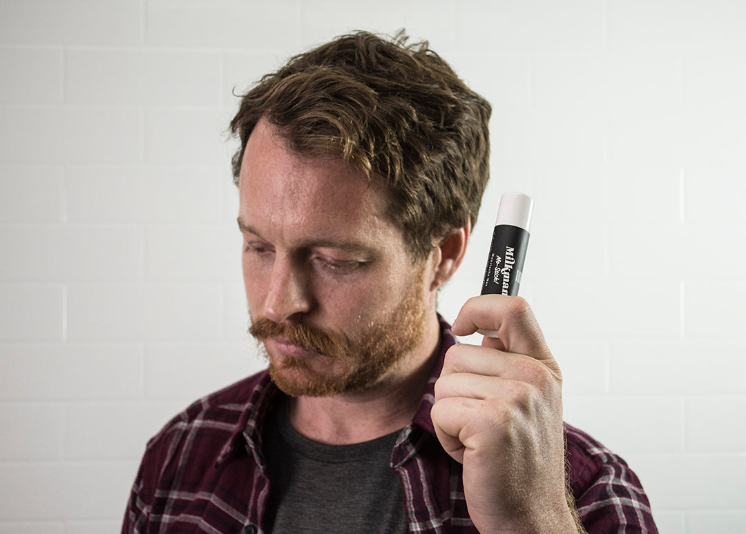 man holding moustache wax