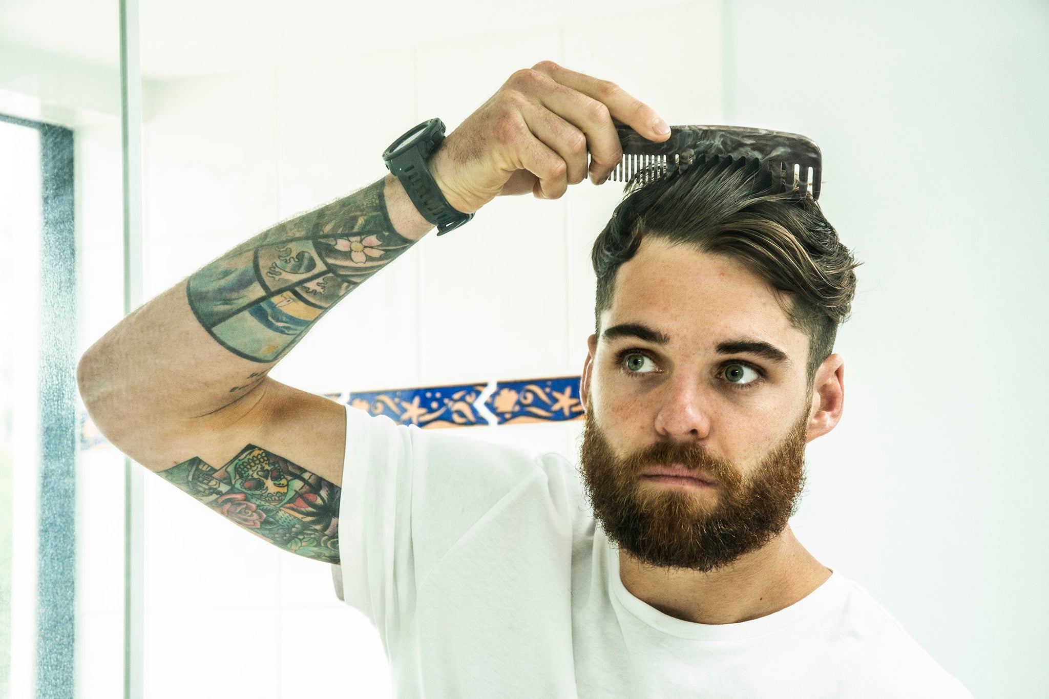 man combing and styling hair