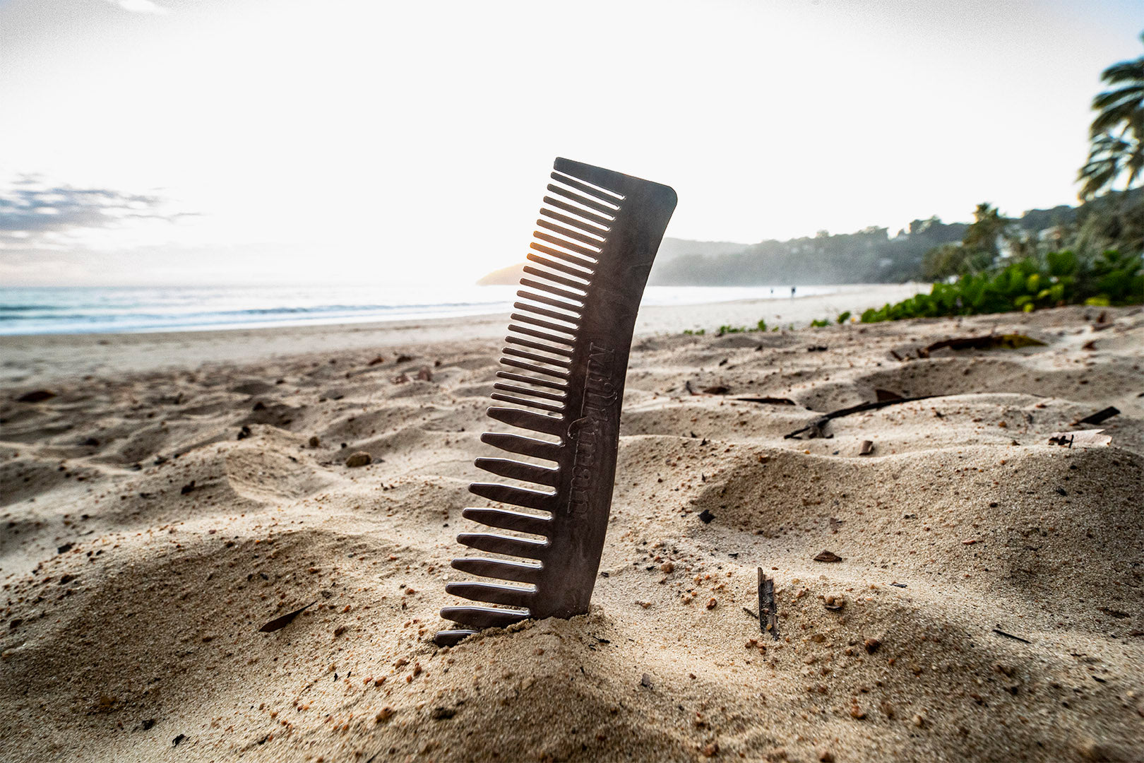 Milkman envirocomb made from recycled plastic bottle caps perched up on the sand at the beard on the sunshine coast queensland