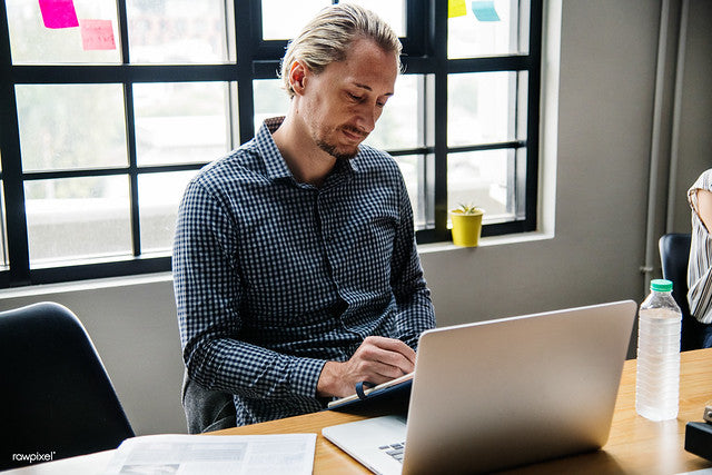 bearded man working at the laptop