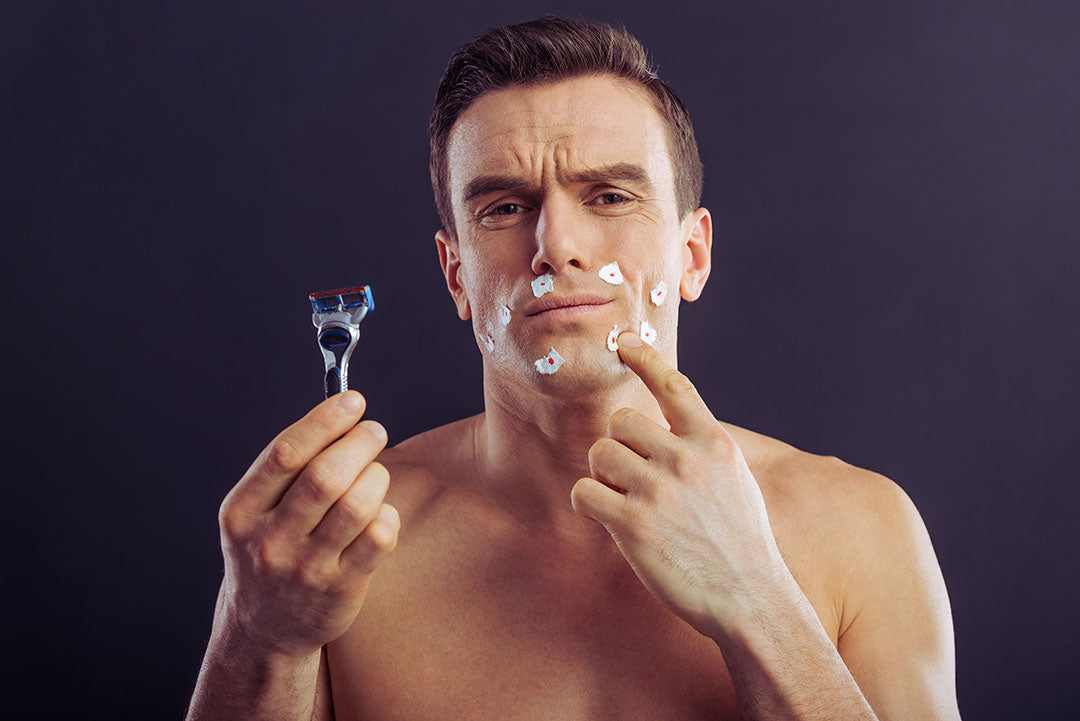 man with razor nicks after a shave