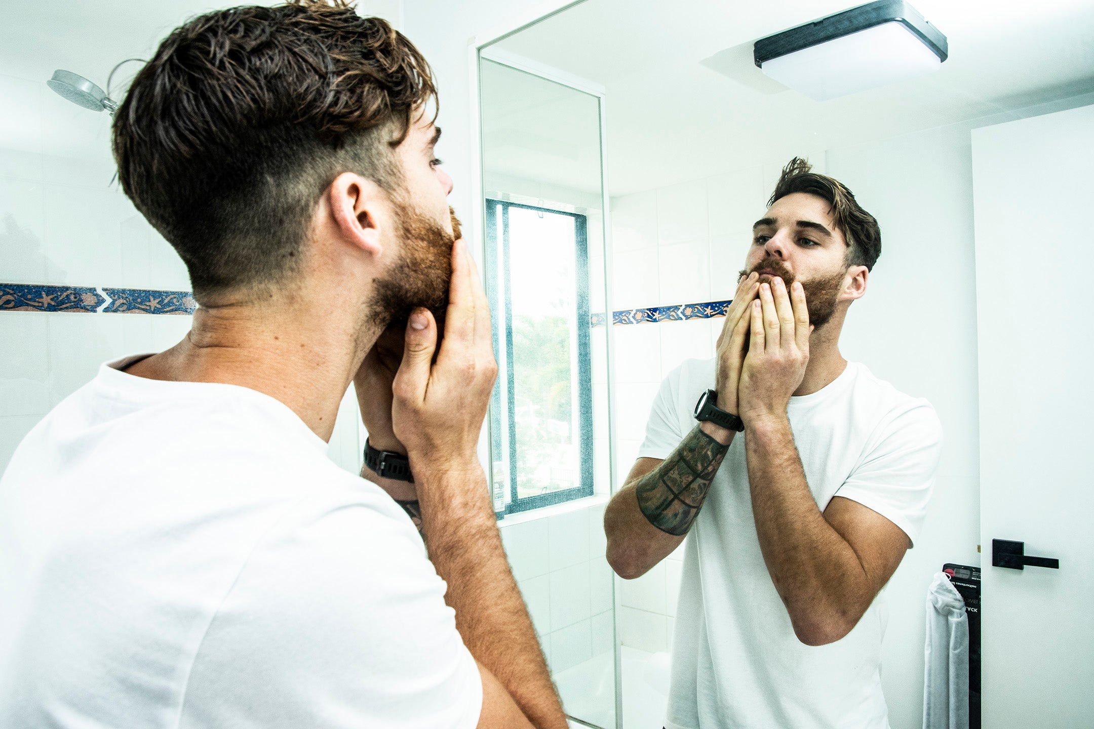 bearded man getting his beard grooming in the morning