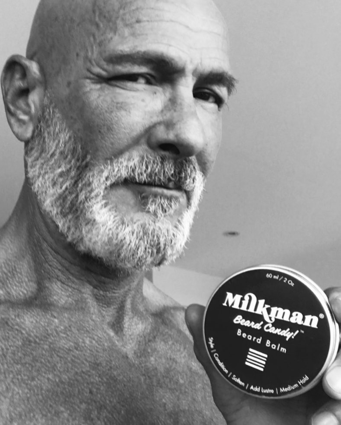 man holding milkman beard balm