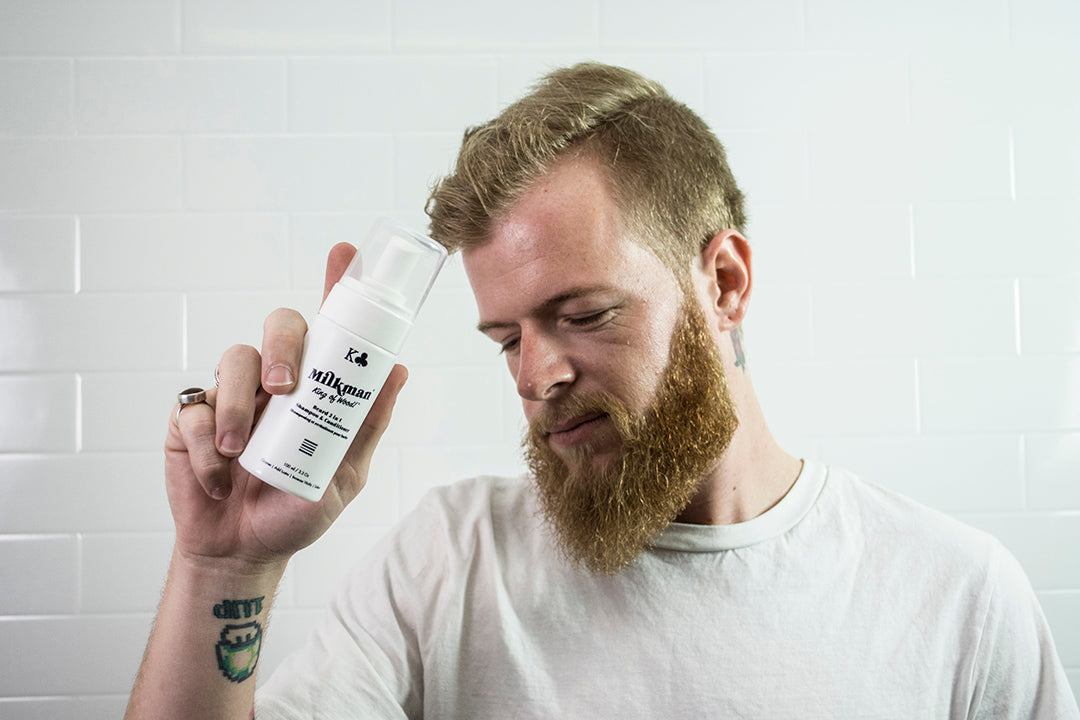 man holding milkman 2 in 1 beard shampoo and conditioner