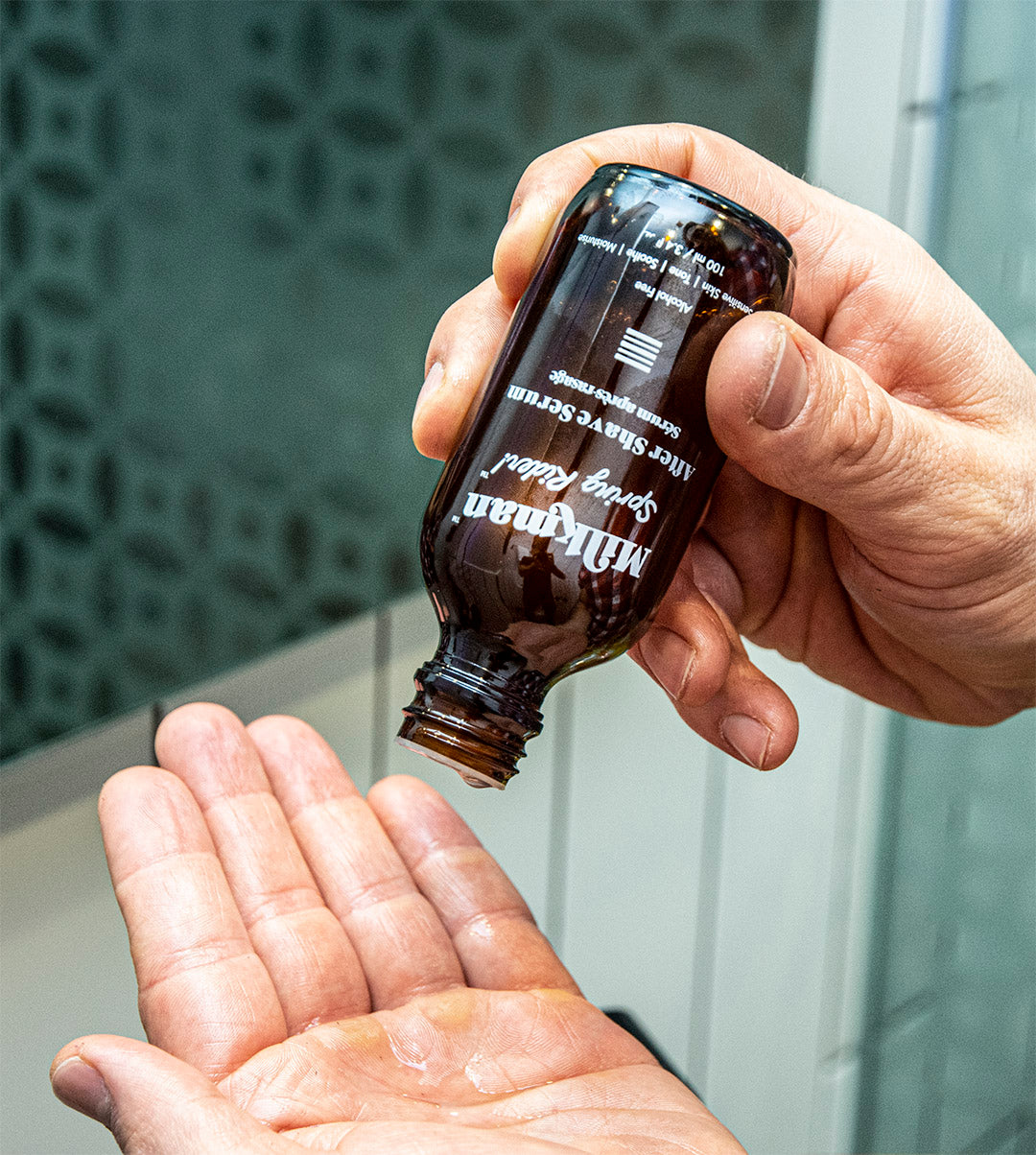 man dispensing after shave serum after a shave