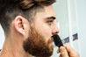 bearded man using milkman pocket comb on his moustache