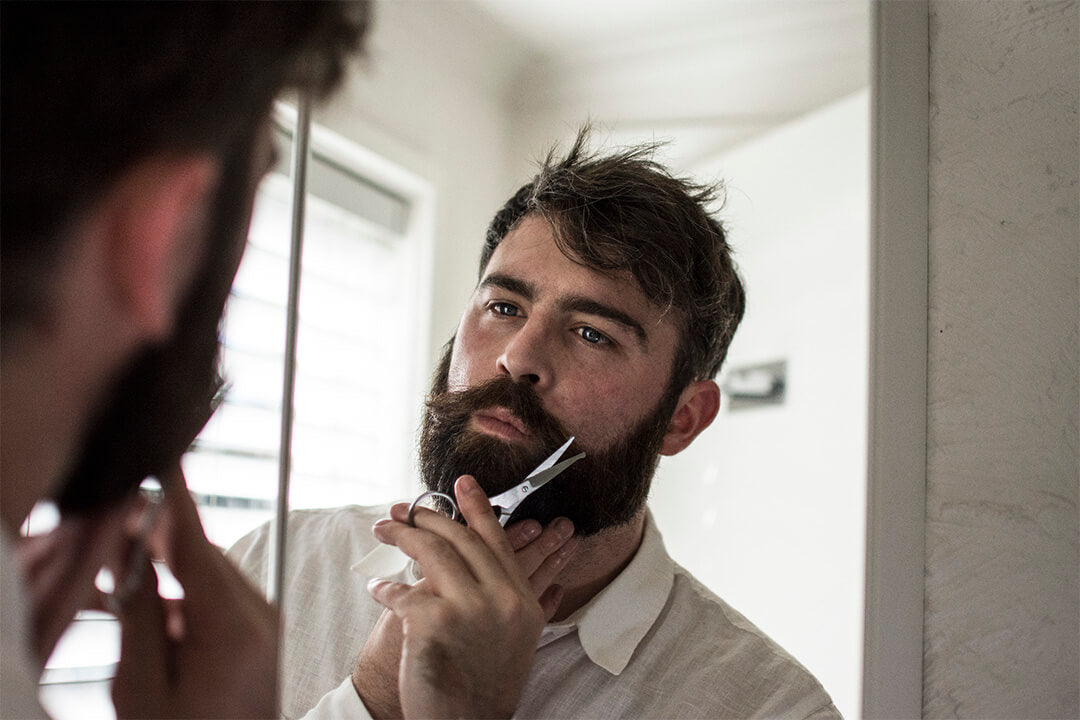 moustache scissor being used by a bearded man