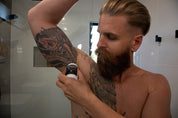 natural deodorant man using in bathroom
