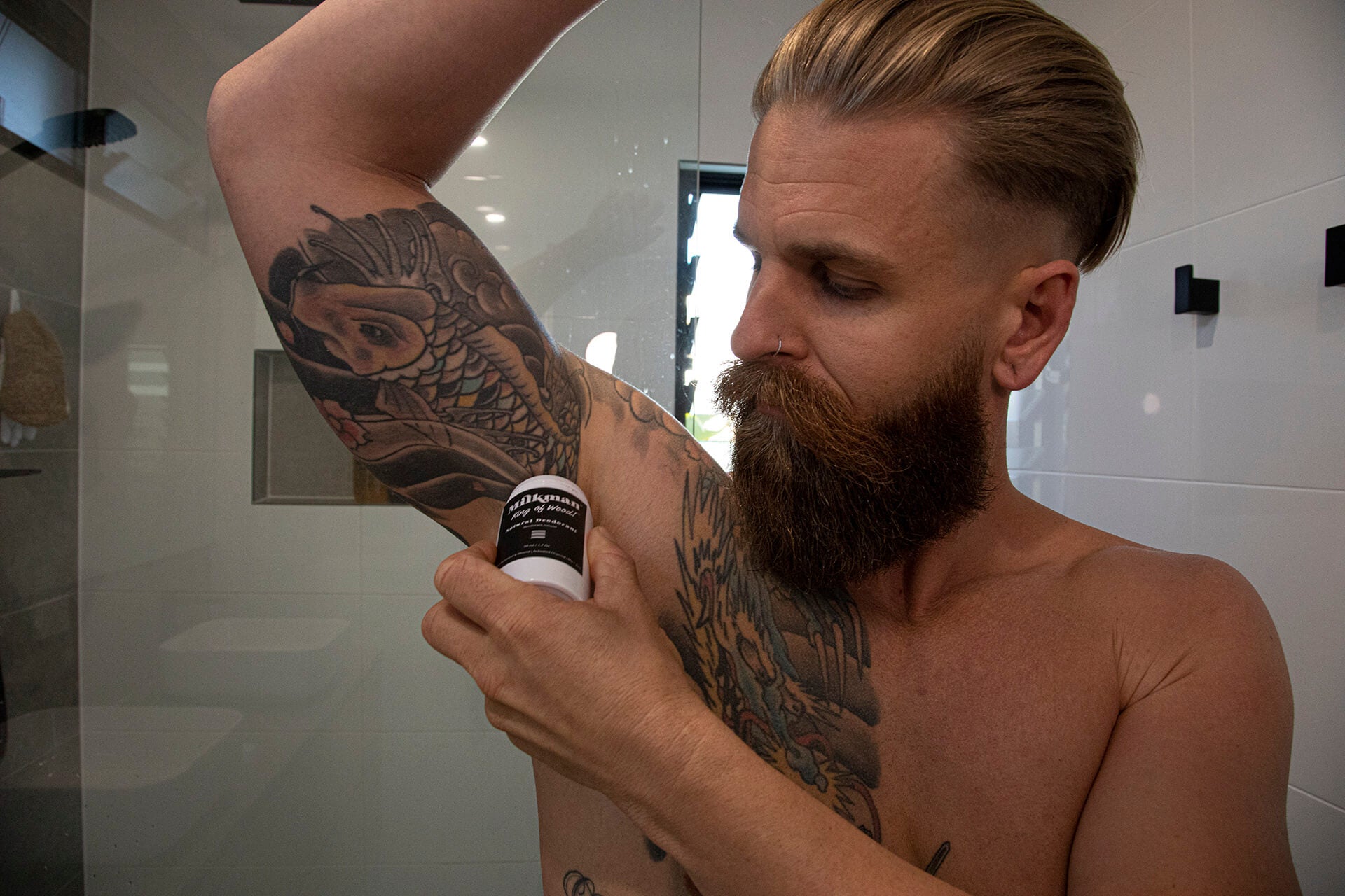 natural deodorant man using in bathroom
